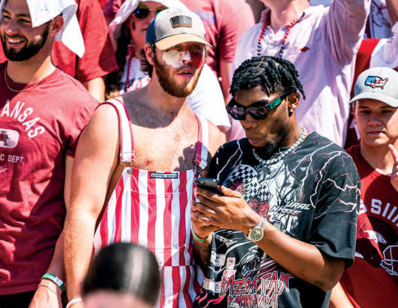 Josh Teeter, a social media personality who attends the University of Arkansas, looks on at a Razorback football game.